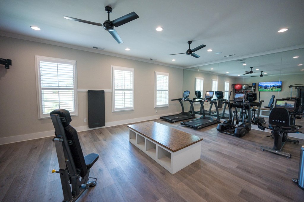 a home gym with exercise equipment and windows