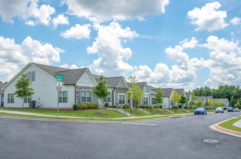 a row of houses on the corner of a street