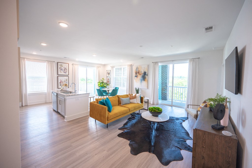 a living room with a yellow couch and a table