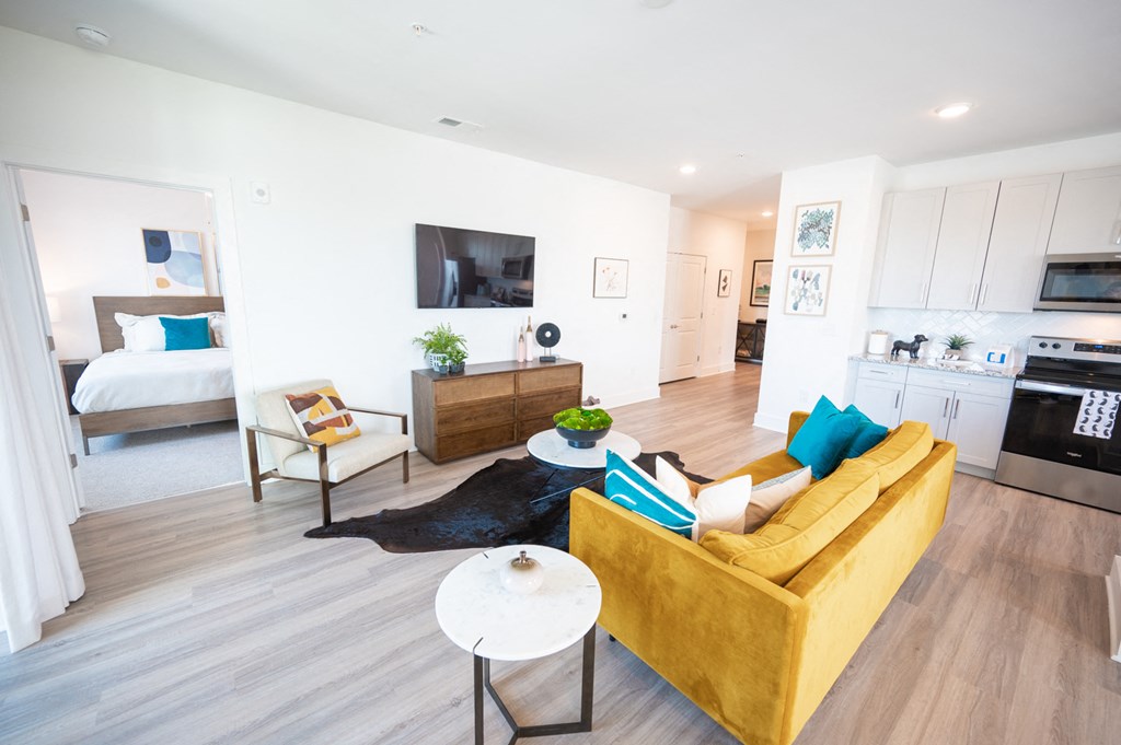 a living room with a yellow couch and a table