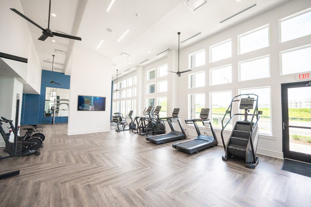 the gym with cardio equipment at the district flats apartments in lenexa