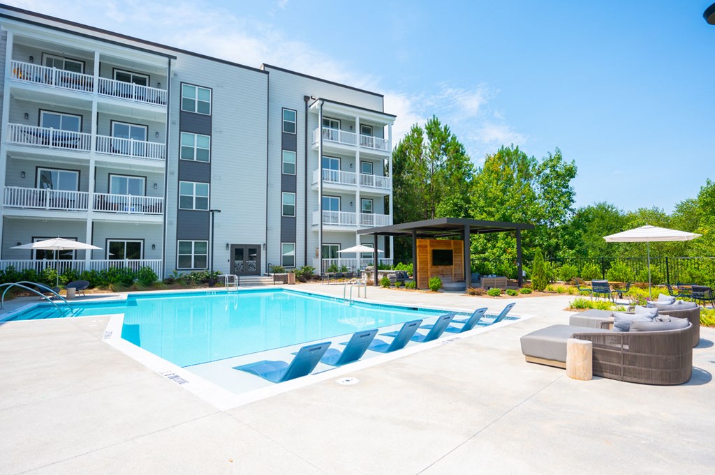 a swimming pool in front of an apartment building
