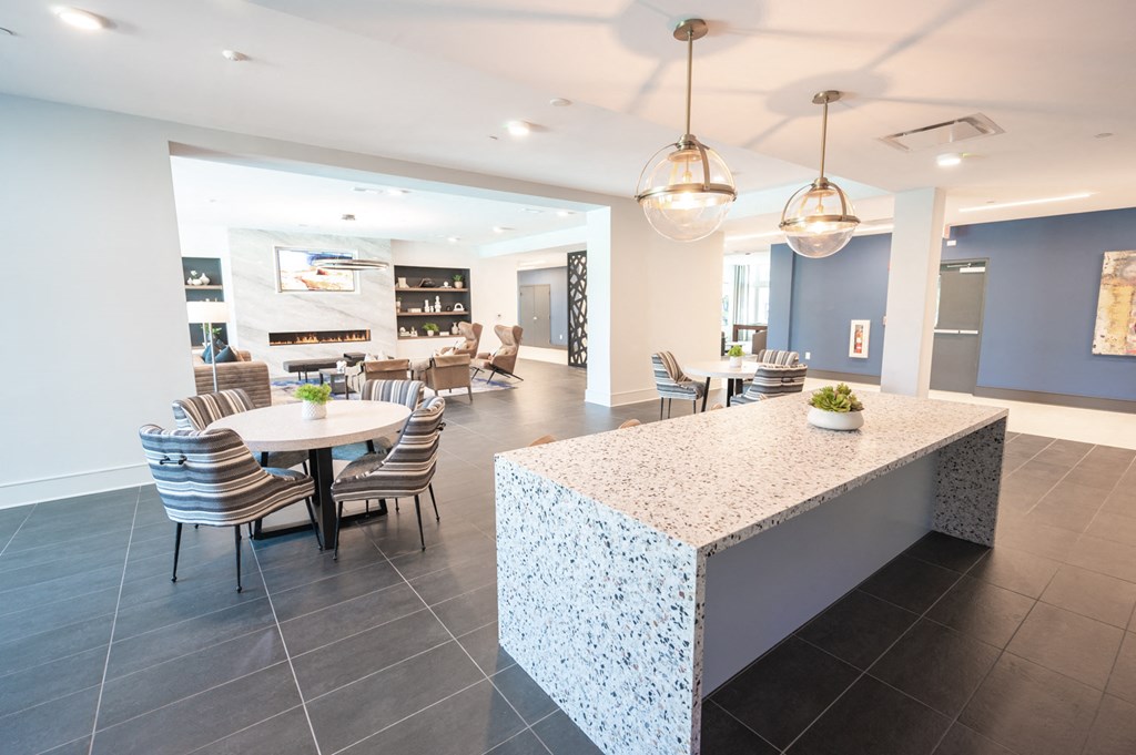 a dining room with a table and chairs and a kitchen