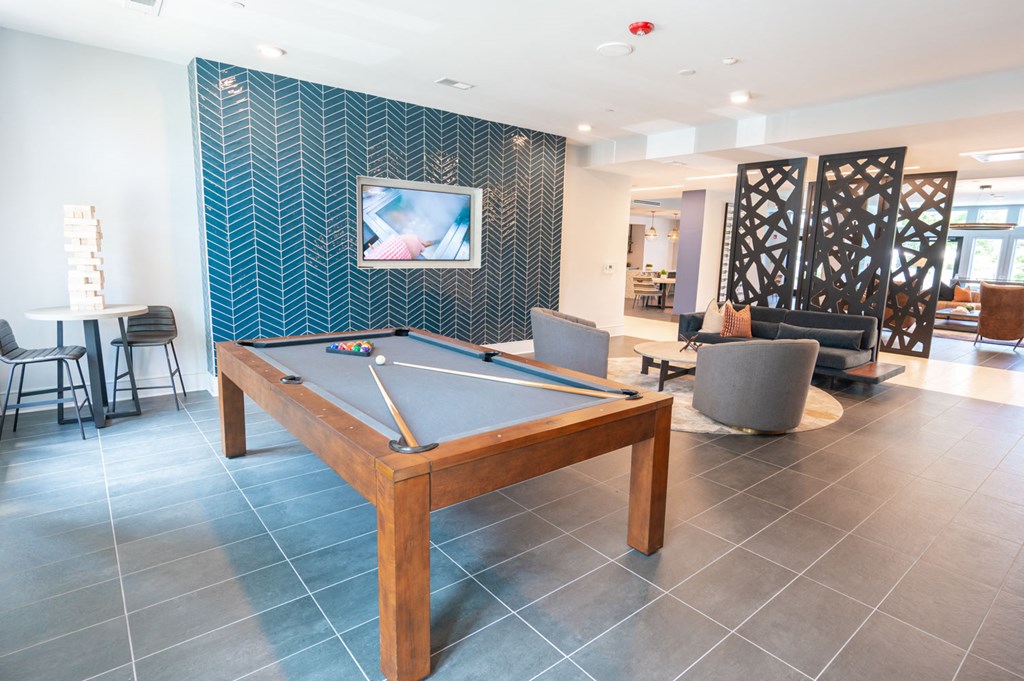 a games room with a pool table and a tv