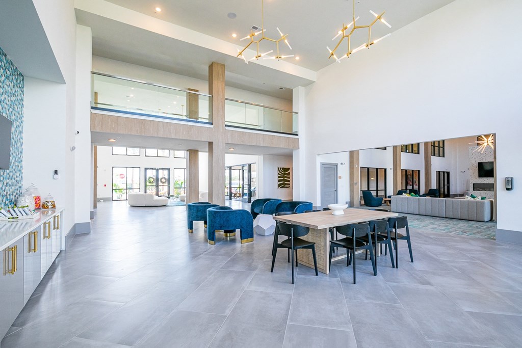 a large open living room with a dining room table and chairs