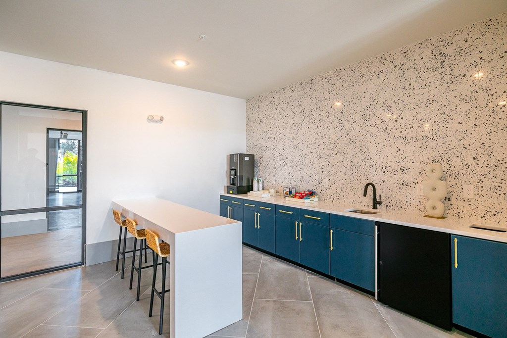 a kitchen with a white counter top and blue cabinets