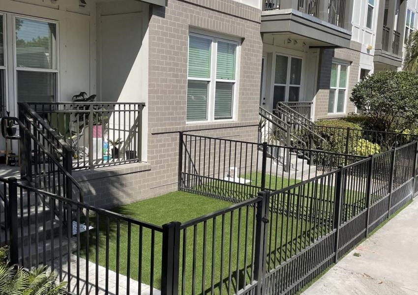 a house with a yard with grass and a fence