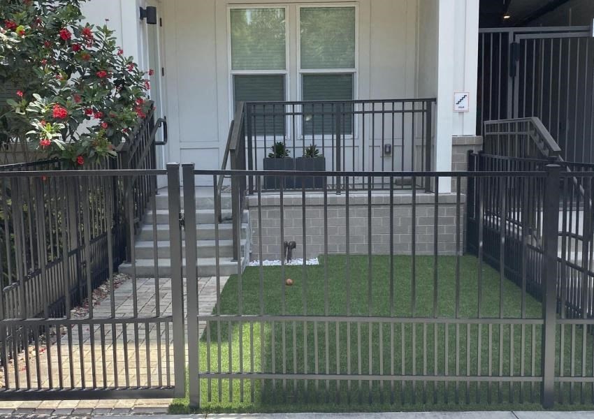 a yard with grass in front of a house