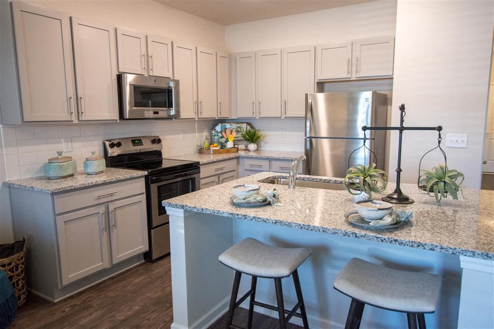 a kitchen with granite counter tops and stainless steel appliances