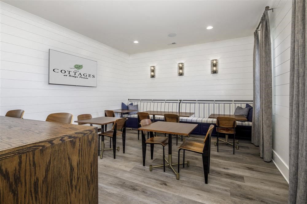 a dining room with tables and chairs and a bar