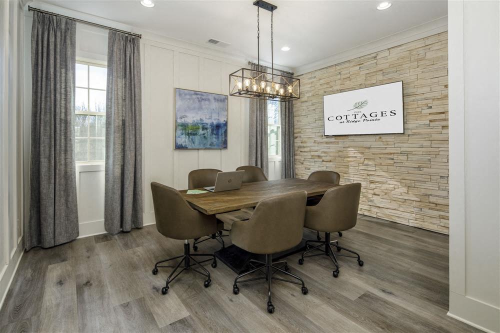 a dining room with a table and chairs and a brick wall