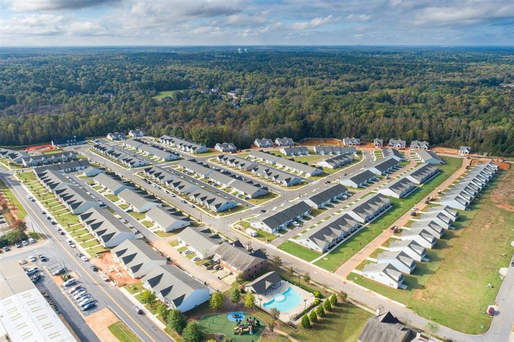 an aerial view of a parking lot of apartments