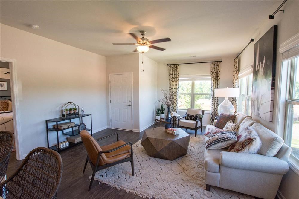 a living room with a couch and a ceiling fan