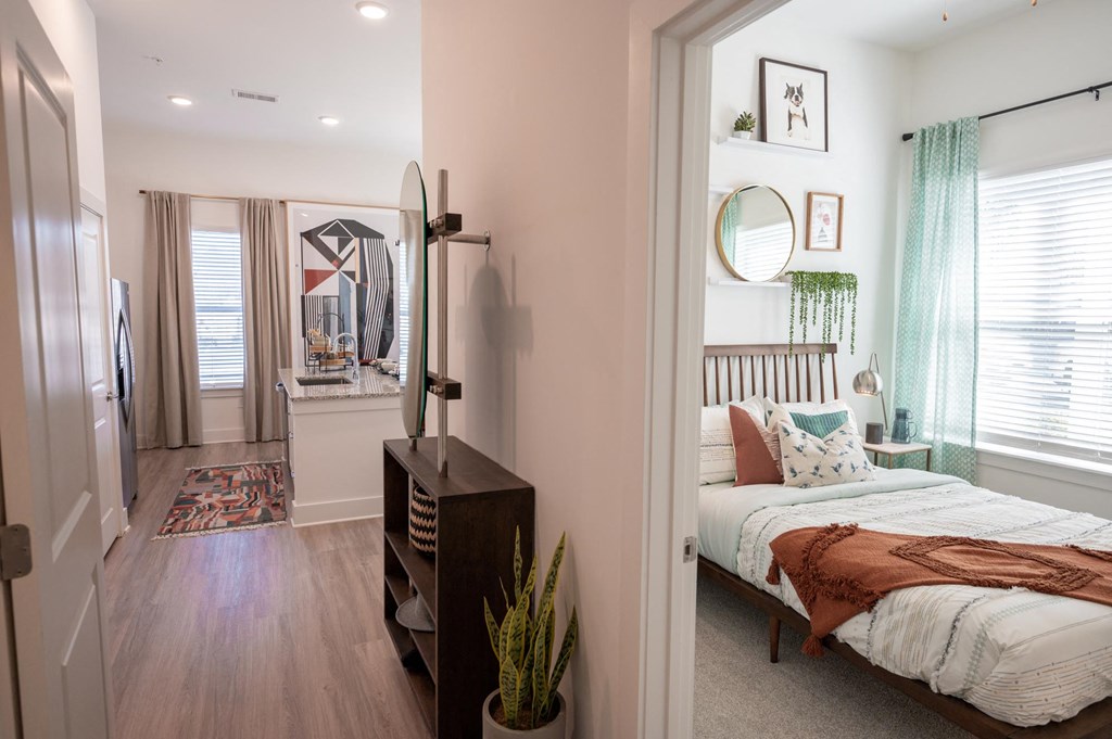 a bedroom with a bed and a closet with a mirror