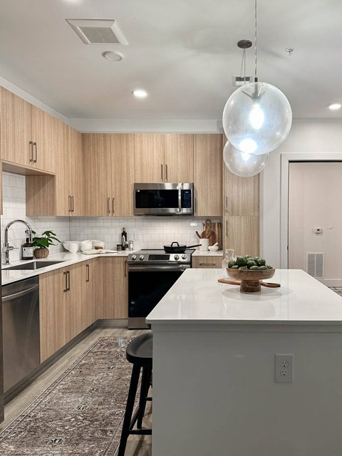 A modern kitchen with wooden cabinets and a white countertop.
