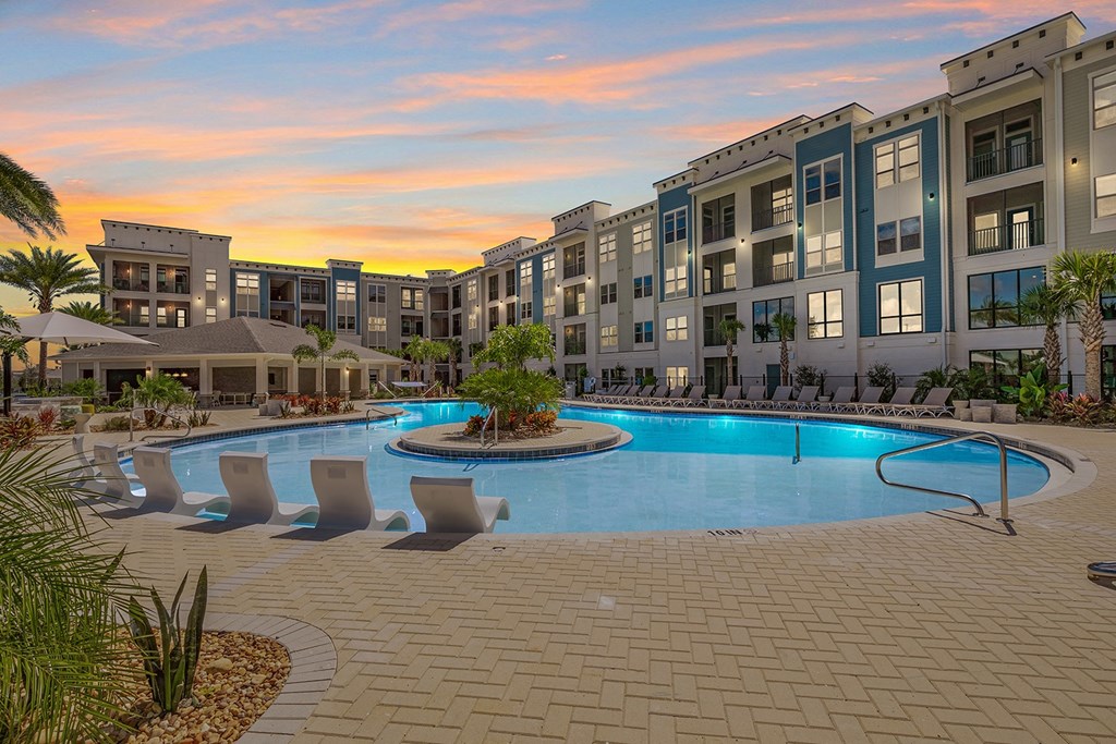 a large swimming pool in front of an apartment building
