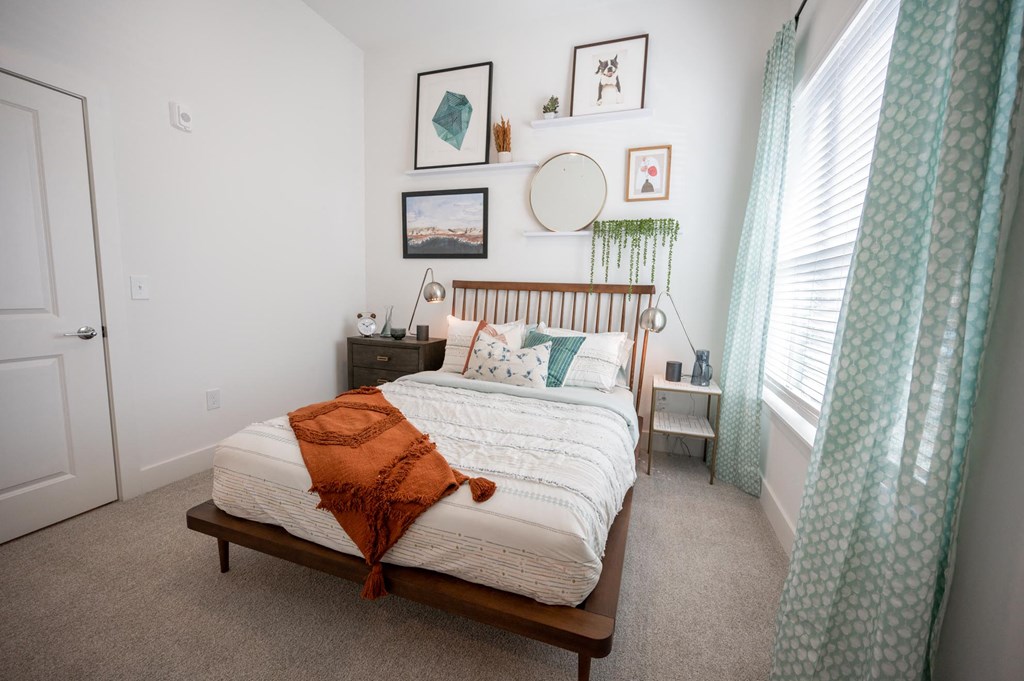 a bedroom with a bed and a green curtain