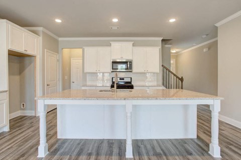 a white kitchen with a large counter top