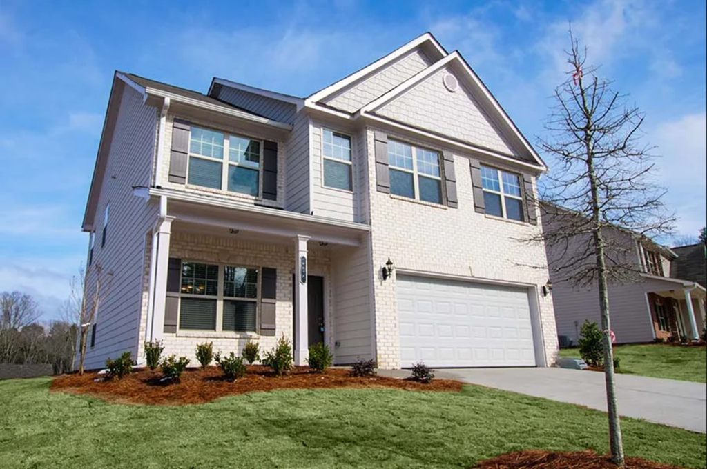 a white house with a lawn in front of it