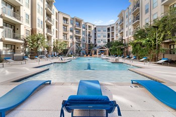 outdoor pool, sundeck and apartment building on sunny day - Photo Gallery 2