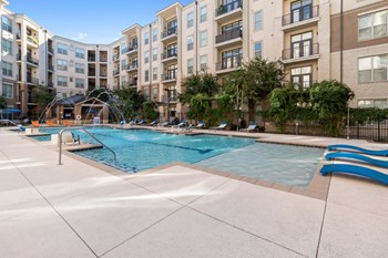 outdoor pool, sundeck and apartment building on sunny day - Photo Gallery 3