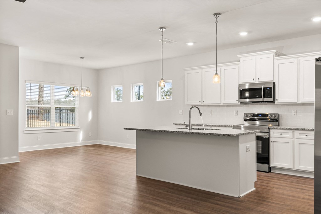 an empty kitchen with a large island in the middle