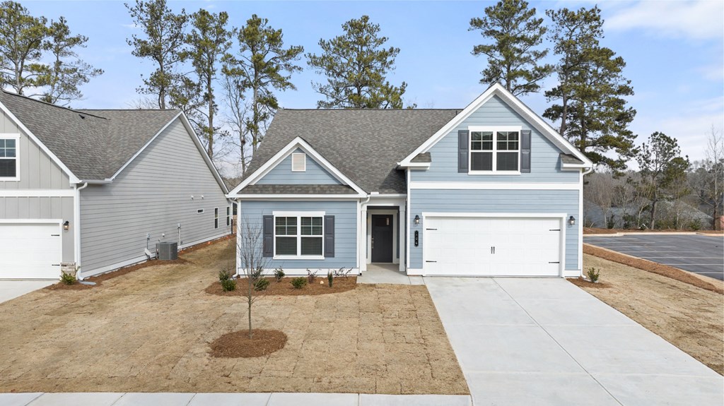 a blue and white house with a garage and a driveway