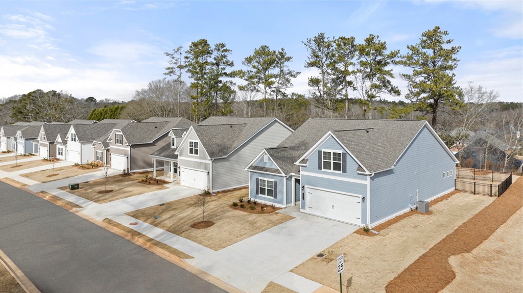 an aerial view of a row of blue houses with gray roofs
