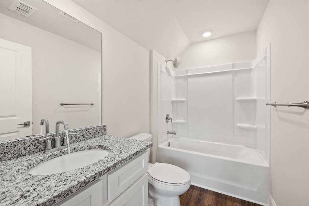 a bathroom with a sink and a toilet and a shower