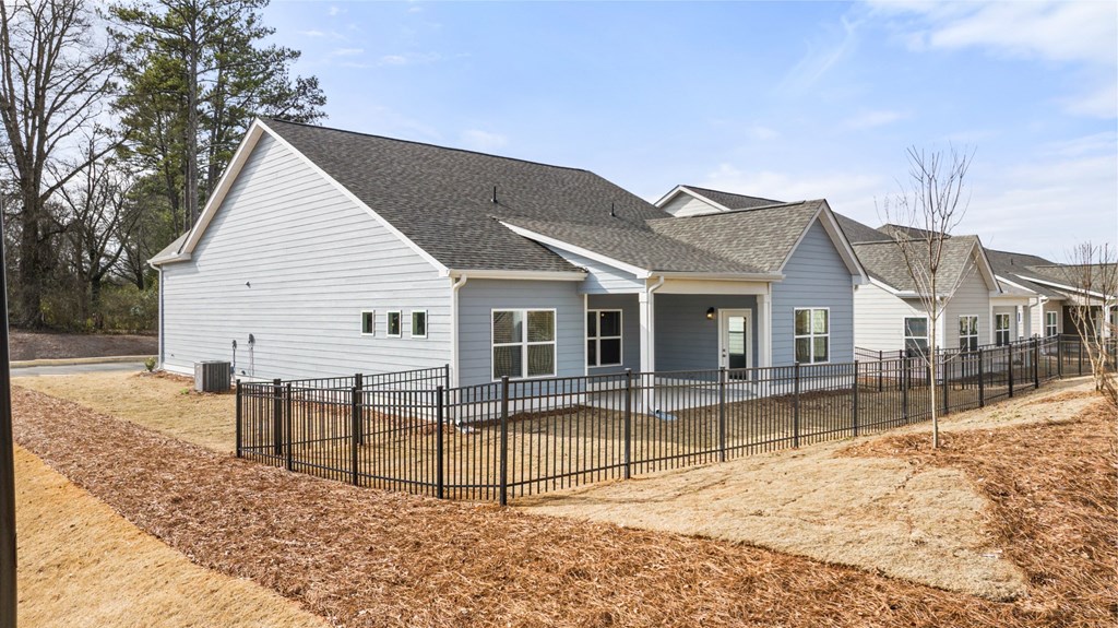 a white house with a fence in front of it