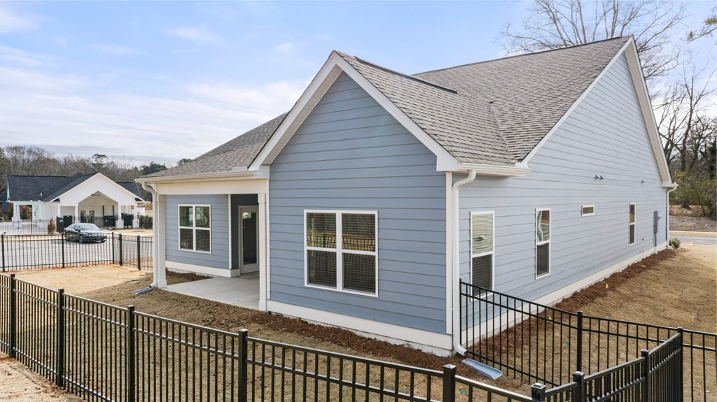 a blue house with a fence in front of it