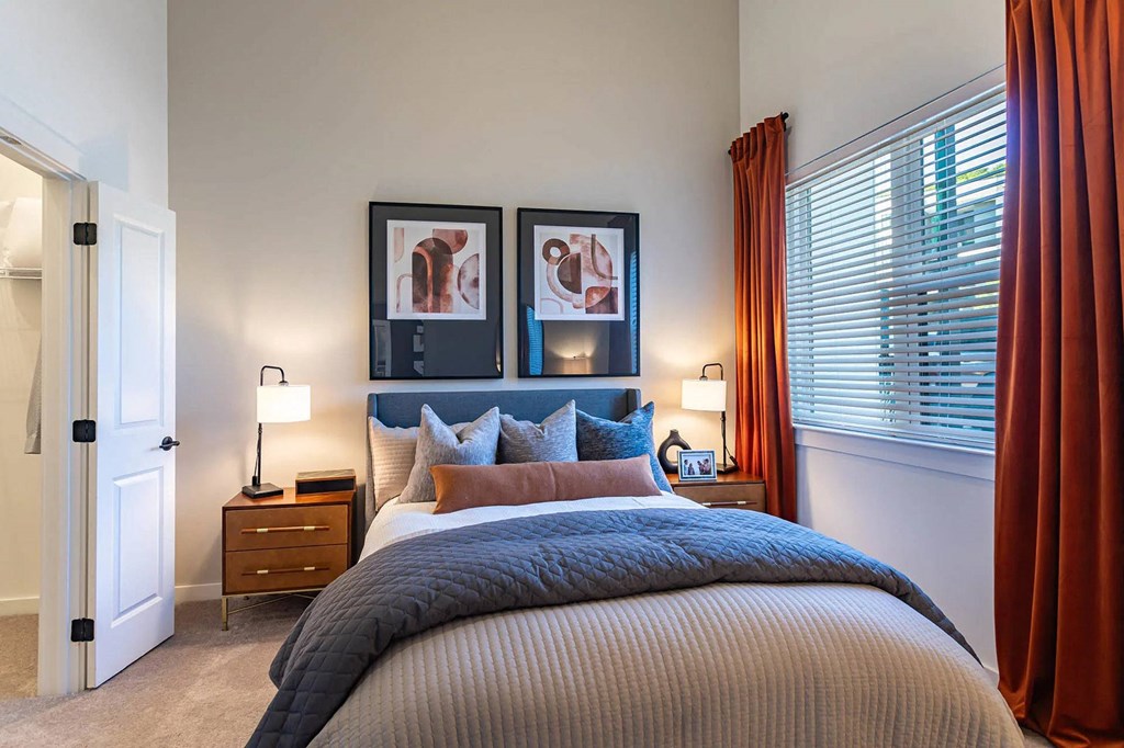 a bedroom with a bed and a windowat Sterling Nashville West Apartments, Tennessee, 37209