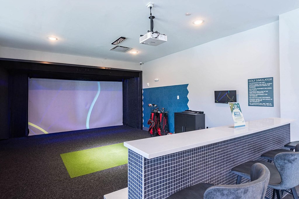 a room with a desk and a projection screenat Sterling Nashville West Apartments, Nashville