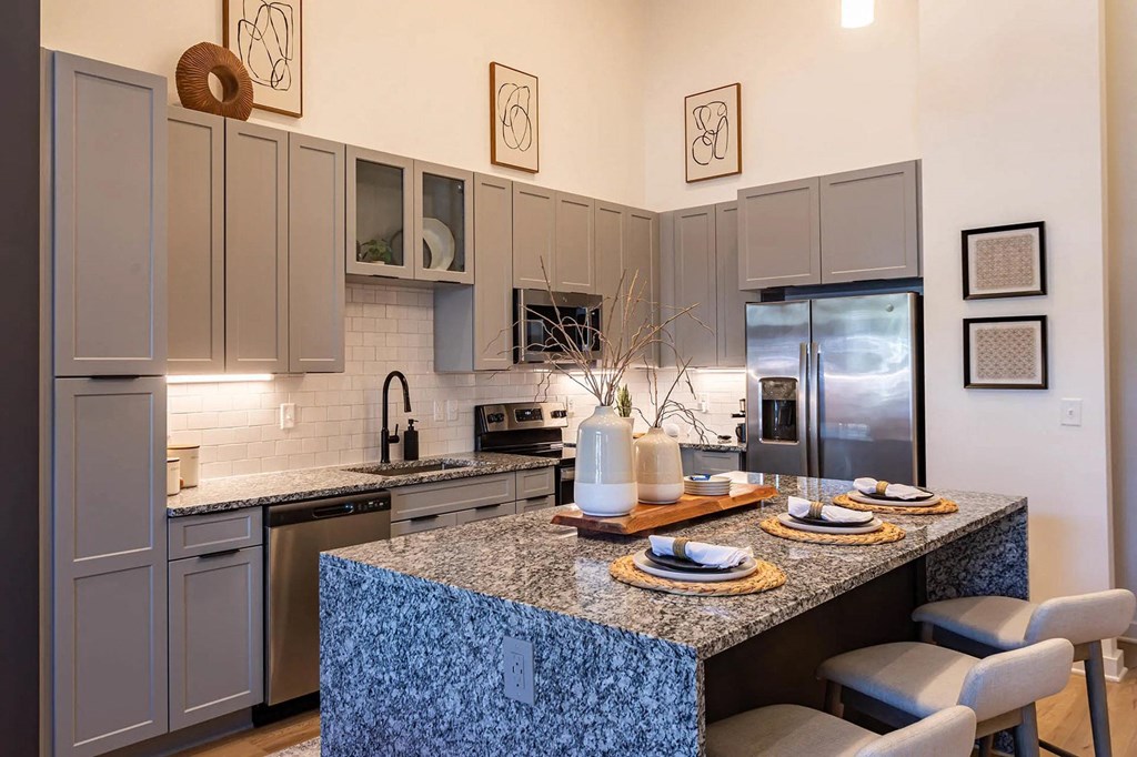 a kitchen with stainless steel appliances and a granite counter topat Sterling Nashville West Apartments, Tennessee, 37209