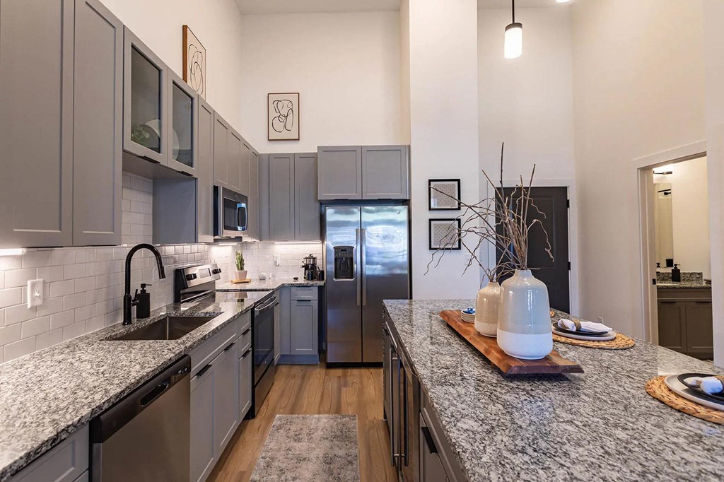 a kitchen with granite counter tops and stainless steel appliancesat Sterling Nashville West Apartments, Nashville, Tennessee
