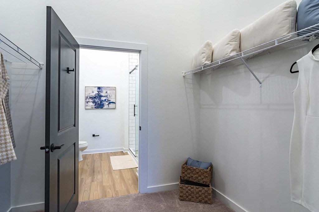 a bedroom with a closet and a door to a bathroomat Sterling Nashville West Apartments, Tennessee