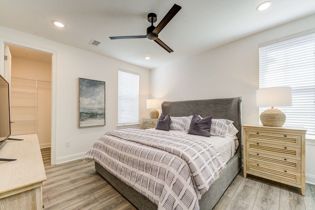 a bedroom with a bed and a ceiling fan