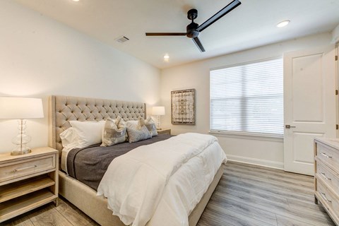 a bedroom with a bed and a ceiling fan
