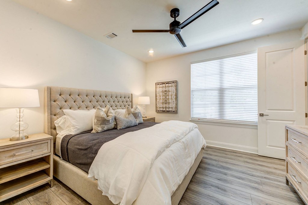 a bedroom with a bed and a ceiling fan