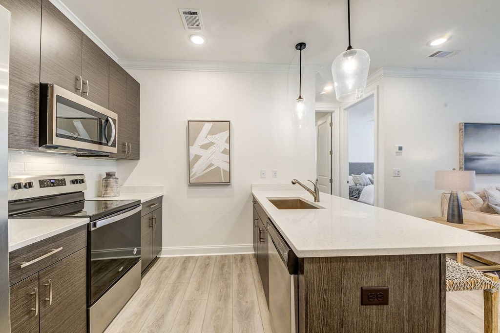 a kitchen with an island and a stove and a microwave