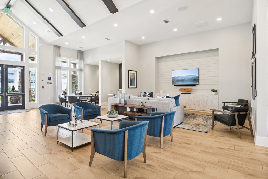 a living room with blue chairs and a white couch