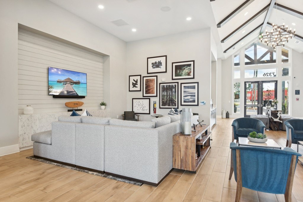 a living room with a white couch and a large window