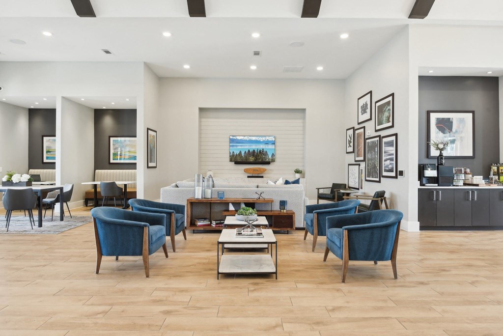 a living room with blue chairs and a table