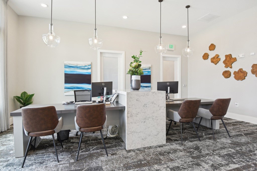 an office with a marble desk and chairs