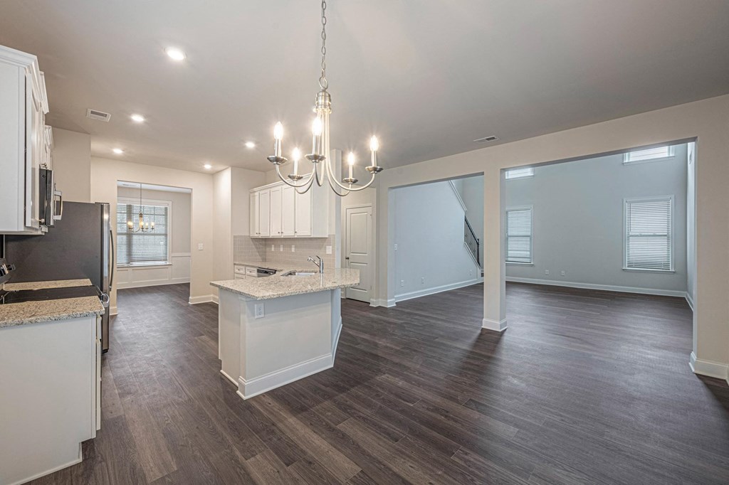 a kitchen and living room with a chandelier