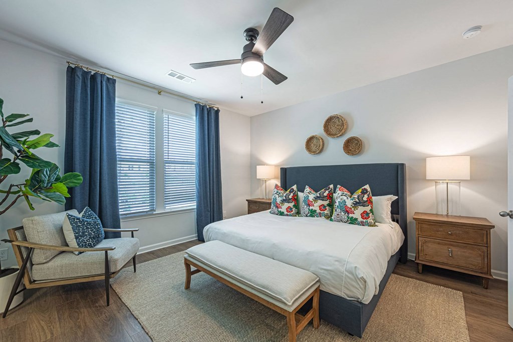 a bedroom with a bed and a ceiling fan