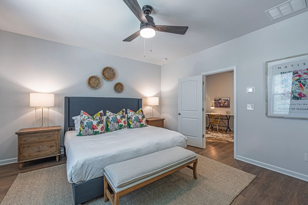 a bedroom with a bed and a ceiling fan