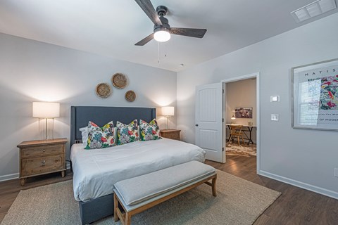 a bedroom with a bed and a ceiling fan