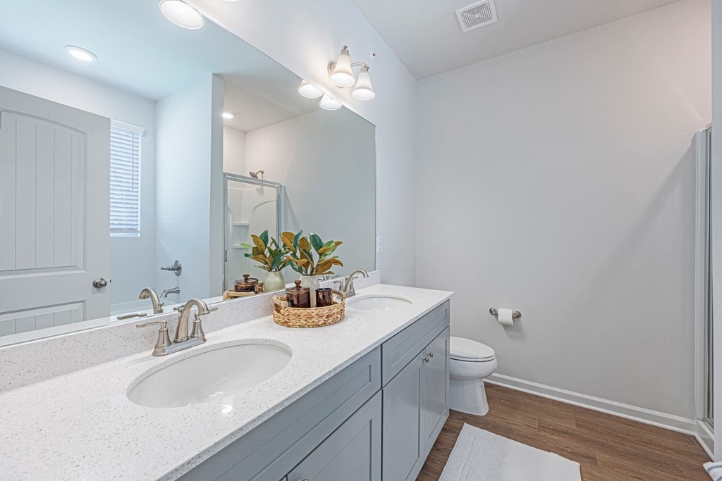 a bathroom with a sink and a toilet and a mirror