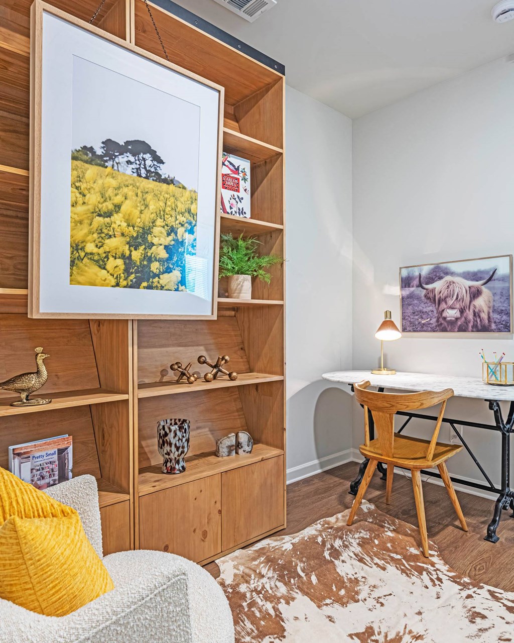 a home office with a desk and a picture on the wall